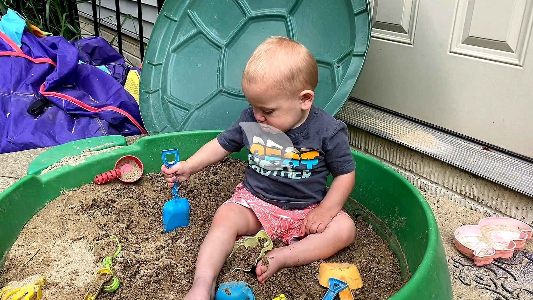 Toddler playing with wooden toys and household props